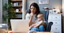 Young female business owner work on laptop from home during maternity leave, running private company with baby in her lap. Businesswoman mother woman with a toddler working at the computer.