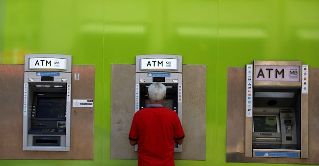 FILE PHOTO: A man uses an ATM at a Novo Banco branch in downtown Lisbon, Portugal September 6, 2017. REUTERS/Rafael Marchante/File Photo