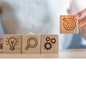 Woman hand holding dartboard above Gear, magnifying and Lightbulb icon block. business planning process, goal, strategy, target, mission, action, research, teamwork and idea concept