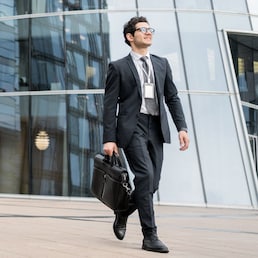 A businessman man goes to work in the office, in a business suit with a briefcase