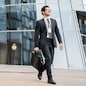 A businessman man goes to work in the office, in a business suit with a briefcase