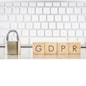 Close keypad lock with word GDPR on wooden cubes, white keyboard on background. European general data protection regulation, personal information, data privacy concepts.