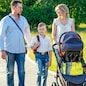 active big family father, mother, son and baby in stroller walking in the park