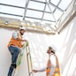 Engineer technician watching team of workers on high steel platform at construction site,Engineer working on construction building site.