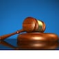 Law, justice and legal system concept with a wooden gavel judge symbol on blue background.