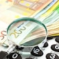 Euro Notes with calculator and magnifier. Closeup