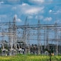 Electrical central where can be seen electric transmission pylons, supporting high voltage lines with visible insulators and other industrial components.