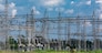 Electrical central where can be seen electric transmission pylons, supporting high voltage lines with visible insulators and other industrial components.
