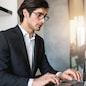 Businessman works at house with a laptop due to coronavirus quarantine.