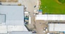 Aerial view of goods warehouse. Logistics center in industrial city zone from above. Aerial view of trucks loading at logistic center