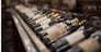 Row of wine bottles with dry red and white wine on wooden. Low depth of field. Winemaking and wine shop concept