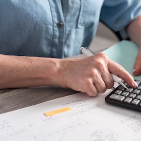 Female accountant using calculator in office