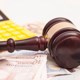 Judge gavel, euro banknotes and calculator