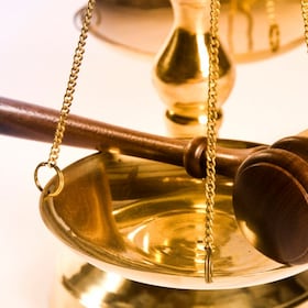 Wooden justice gavel and block with brass