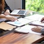 Businesswoman Accountant analyzing investment charts Invoice and pressing calculator buttons over documents. Accounting Bookkeeper Clerk Bank Advisor And Auditor.
