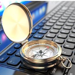 Online navigation. Compass on laptop keyboard. 3d