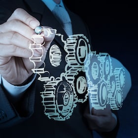 businessman hand draws gear to success concept