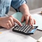 Female accountant using calculator in office