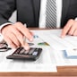 Businessman working with using a calculator to calculate the numbers. Finance accounting concept