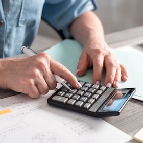 Female accountant using calculator in office