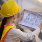 Woman Engineering design hard hat safety suit holding blueprint inspection building estate construction,Working woman