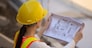 Woman Engineering design hard hat safety suit holding blueprint inspection building estate construction,Working woman