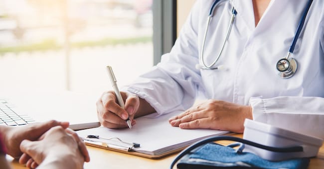 The doctor is discussing with the patient after a physical examination of the results and treatment guidelines.