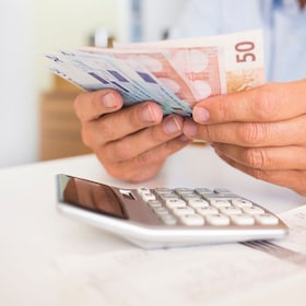 Male hand computer calculator money pen