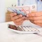 Male hand computer calculator money pen