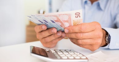 Male hand computer calculator money pen