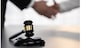 Focus gavel symbolize justice on blur background of lawyer colleagues handshake after successful legal deal for lawsuit to advocate resolves dispute in court ensuring trustworthy partner. Equilibrium