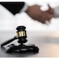 Focus gavel symbolize justice on blur background of lawyer colleagues handshake after successful legal deal for lawsuit to advocate resolves dispute in court ensuring trustworthy partner. Equilibrium