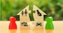 Two human figures divide the house among themselves. Divorce concept. Execution of the posthumous will. Disputes over division process of real estate and property between former spouses, relatives.