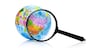 Globe under magnifying glass zooming Russia and China on white background