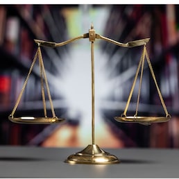 Shiny golden balanced scale in court library background as concept justice and fairness legal symbol. Scale balance for righteous and equality judgment by lawyer and attorney. equility