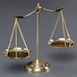 Shiny golden balanced scale in courtroom background as concept justice and a common legal symbol. Scale balance for righteous and equality judgment by lawyer and attorney. Equilibrium