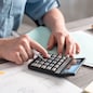 Female accountant using calculator in office