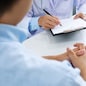 close up of patient and doctor taking notes in a hospital or clinic