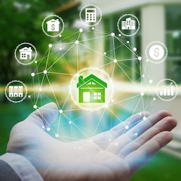 Hand holding with property investment Icons over the Network connection on property background, Property investment concept.