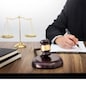 lawyer hand writes the document in court (justice, law) with sounding block and golden Weight.