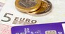 Macro of debit card and on top of euro note to illustrate currency crisis in Europe