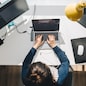 woman working on laptop at home. telework. freelance concept. overhead view