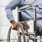 Man sitting in wheelchair at home.