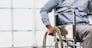 Man sitting in wheelchair at home.
