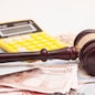 Judge gavel, euro banknotes and calculator