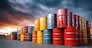 Metal oil barrels stacked in industrial yard, representing commodity storage, energy and petroleum sector