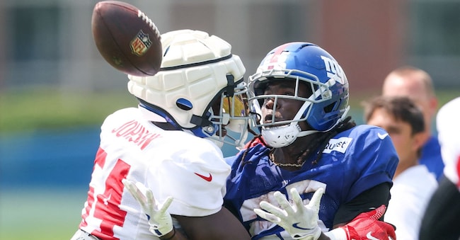 Aug 4, 2025; East Rutherford, NJ, USA; New York Giants linebacker Dyontae Johnson (54) breaks up a pass intended for running back Dante Miller (25) during training camp at Quest Diagnostics Training Center. Mandatory Credit: Vincent Carchietta-Imagn Images