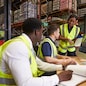 Team discussing warehouse logistics in an on-site office