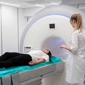 Female patient undergoing MRI - Magnetic resonance imaging in Hospital. Medical Equipment and Health Care.