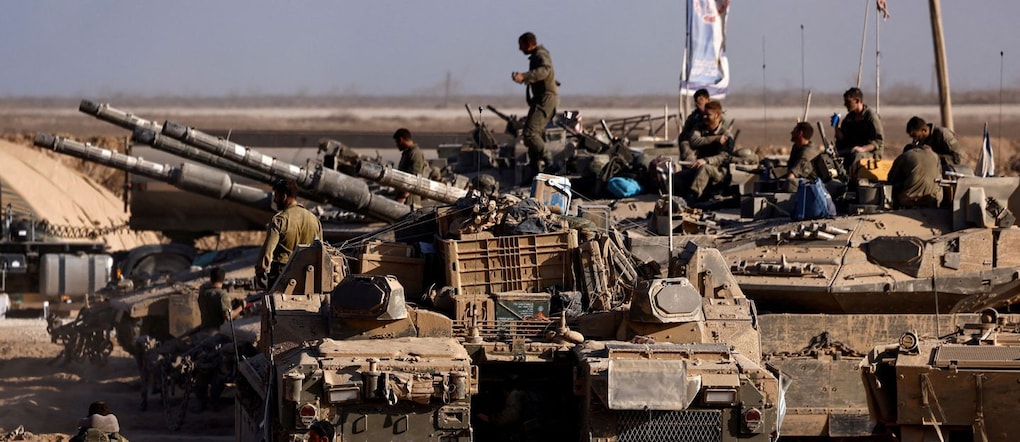 Israeli soldiers get out from an Israeli armoured personnel carrier (APC) after entering Israel from Gaza, at the Israel-Gaza border, as seen from Israel, August 26, 2025. REUTERS/Amir Cohen